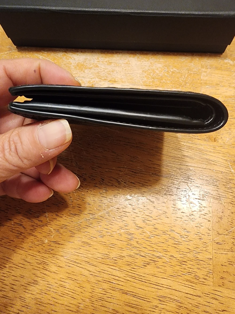 black Coach 3-in-1 wallet featuring the brand's iconic debossed signature pebble